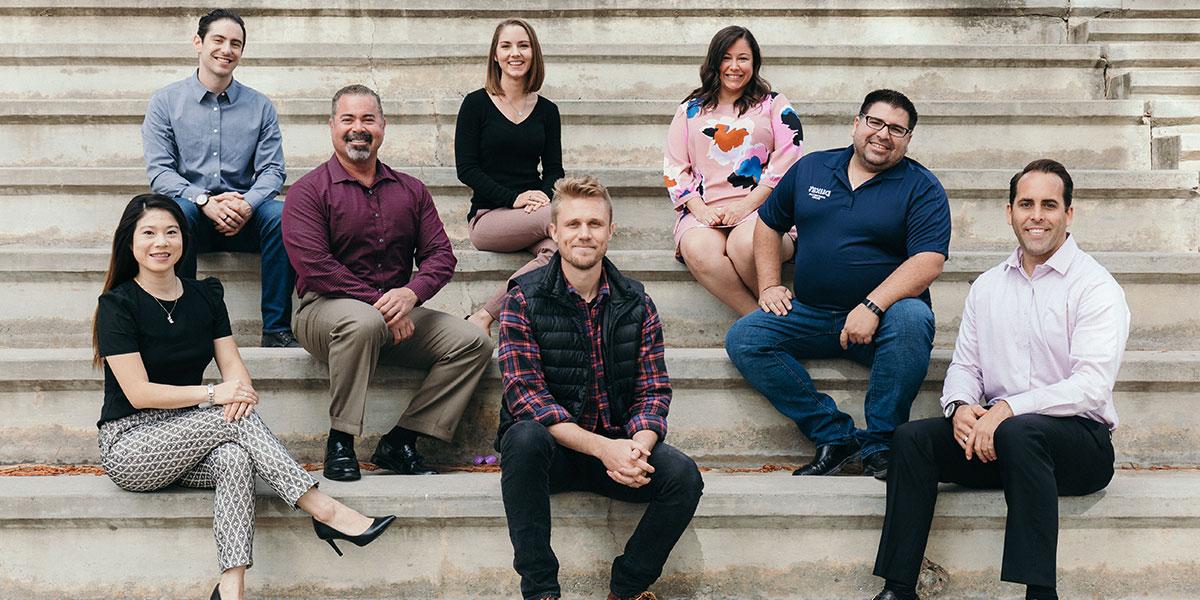 The MBA8 students sitting on amphitheatre steps